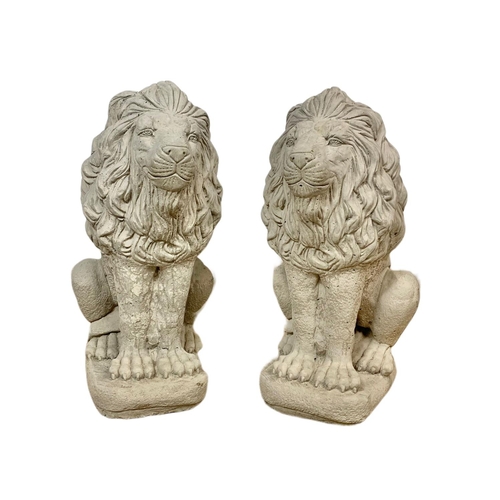 121 - Pair of concrete garden lions. 33 x 59cm