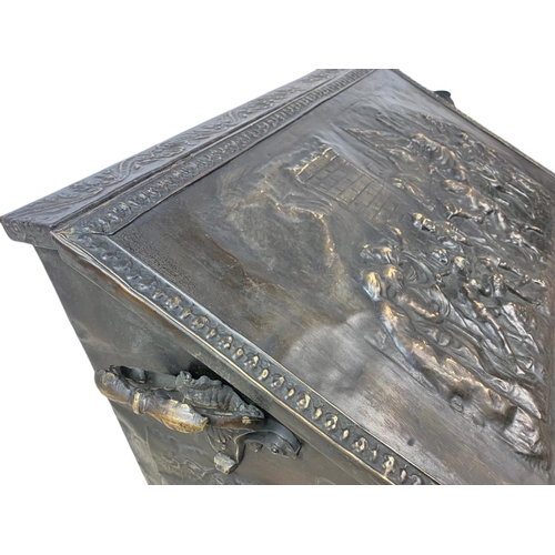 194 - Large Victorian ornate brass log box with lion paw feet and medieval decoration. 71 x 38 x 48cm