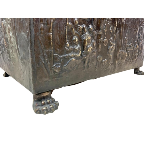 194 - Large Victorian ornate brass log box with lion paw feet and medieval decoration. 71 x 38 x 48cm