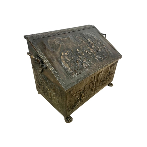 194 - Large Victorian ornate brass log box with lion paw feet and medieval decoration. 71 x 38 x 48cm