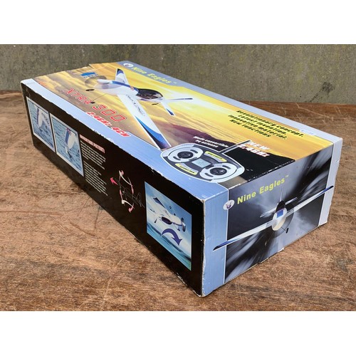 14 - Nine Eagles XTRA 300 2.4GHZ 4CH remote control plane in box. Box measures 57.5 x 26cm