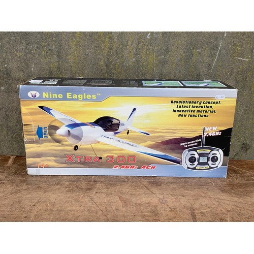 14 - Nine Eagles XTRA 300 2.4GHZ 4CH remote control plane in box. Box measures 57.5 x 26cm