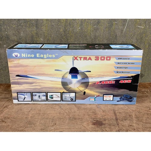 14 - Nine Eagles XTRA 300 2.4GHZ 4CH remote control plane in box. Box measures 57.5 x 26cm