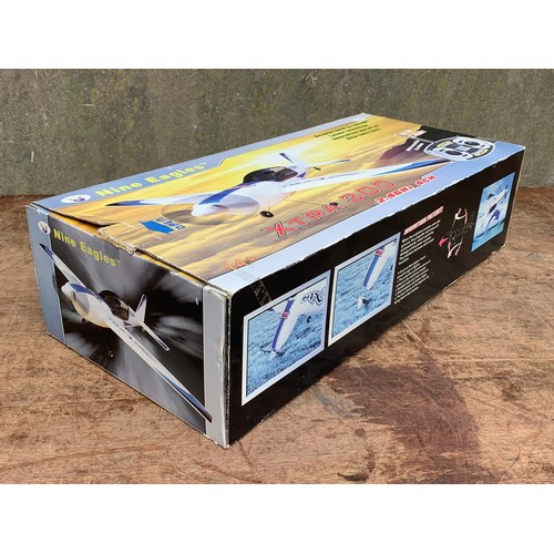 14 - Nine Eagles XTRA 300 2.4GHZ 4CH remote control plane in box. Box measures 57.5 x 26cm