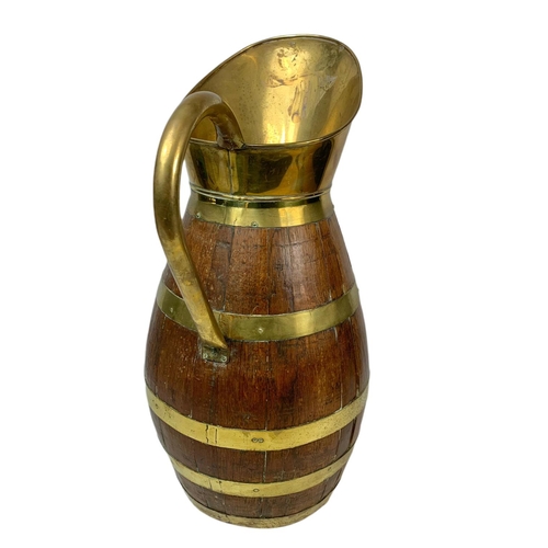 113 - Large Edwardian oak brass bound jug. 63cm