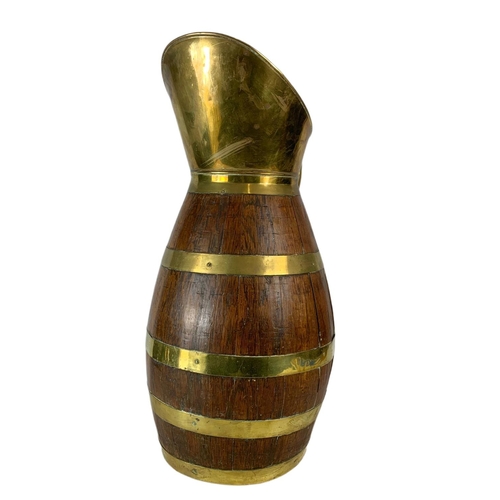 113 - Large Edwardian oak brass bound jug. 63cm