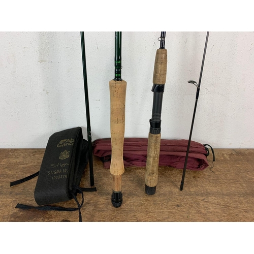 115 - 2 fishing rods. 1 sea rod by Abu Garcia Stigma in bag and fly rod by Shimano in bag.