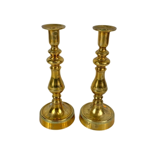 188 - Pair of vintage brass candlesticks with a pair of vintage spectacles, 25.5cm