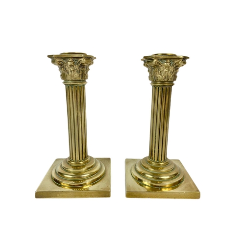 210 - Pair of Victorian brass Corinthian style candle sticks. 18cm