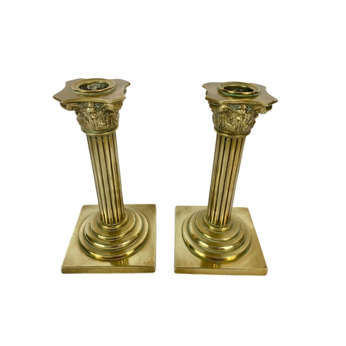 210 - Pair of Victorian brass Corinthian style candle sticks. 18cm