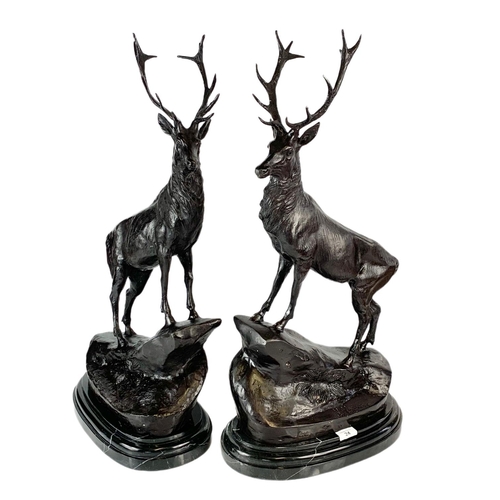 24 - Pair of bronze stags, signed J. Moigniez, 73.5cm