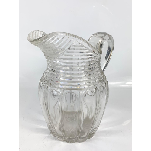 454 - 2 Victorian heavy cut glass jugs. Largest is 21x20cm