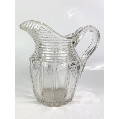 454 - 2 Victorian heavy cut glass jugs. Largest is 21x20cm