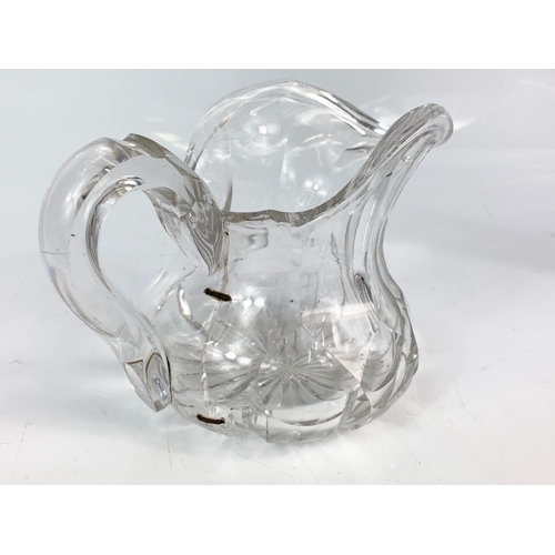 454 - 2 Victorian heavy cut glass jugs. Largest is 21x20cm