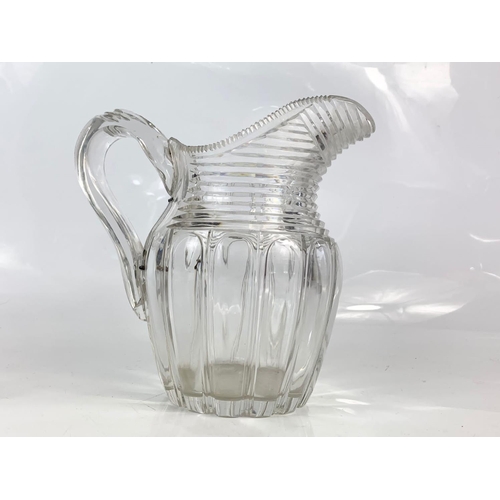 454 - 2 Victorian heavy cut glass jugs. Largest is 21x20cm