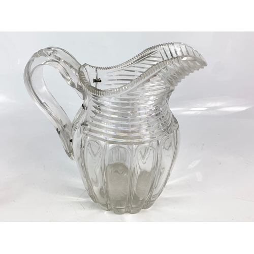 454 - 2 Victorian heavy cut glass jugs. Largest is 21x20cm