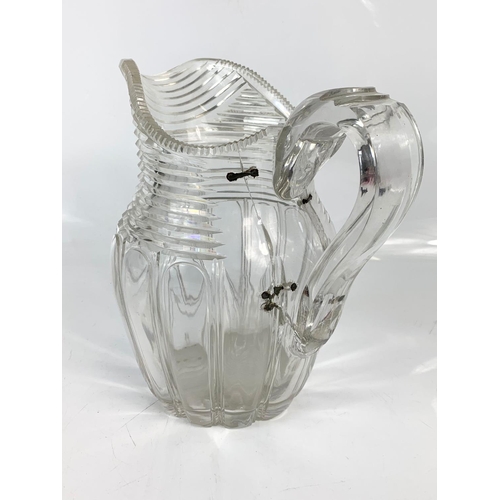 454 - 2 Victorian heavy cut glass jugs. Largest is 21x20cm