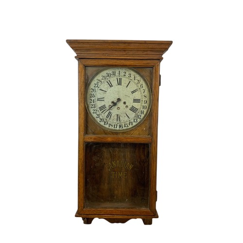 354 - Early 20th century oak case wall clock by Arthur Pequegnat. Circa 1910. 39 x 91cm