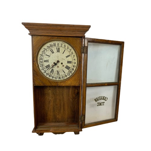 354 - Early 20th century oak case wall clock by Arthur Pequegnat. Circa 1910. 39 x 91cm