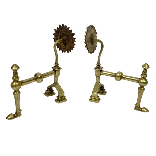 232 - Victorian brassware. Including a pair of fire dogs and 2 trivet stands. Largest stand measures 25.5c... 