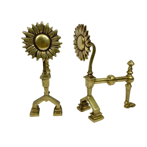 232 - Victorian brassware. Including a pair of fire dogs and 2 trivet stands. Largest stand measures 25.5c... 