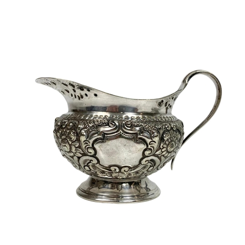 490 - Early 20th century silver plated wine bottle holder, sugar bowl and milk jug, 19cm