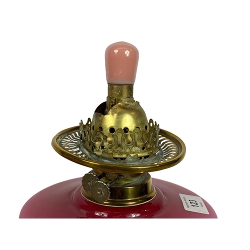 123 - Early 20th century brass and ruby glass lamp. Electrified. 42cm