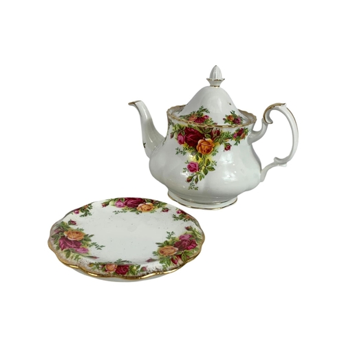 569 - Royal Albert Old Country Roses teapot on stand with tea cozy and towel. Pot measures 22 x 17cm