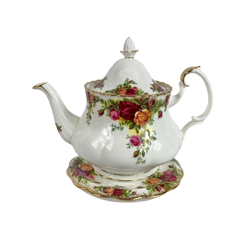 569 - Royal Albert Old Country Roses teapot on stand with tea cozy and towel. Pot measures 22 x 17cm