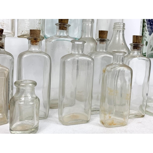 585 - Quantity of early 20th century glass bottles and jars