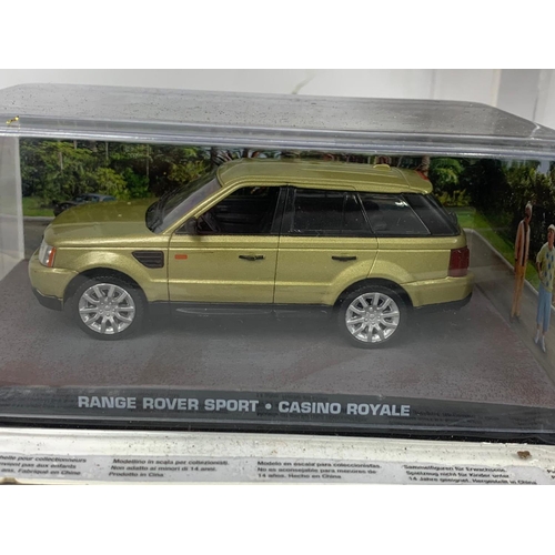 373a - 7 James Bond 007 model cars in display cases. 18cm