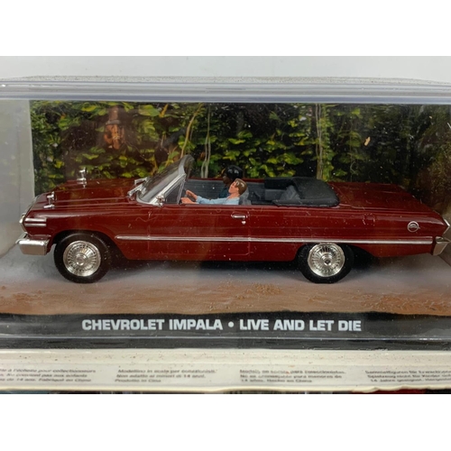 373a - 7 James Bond 007 model cars in display cases. 18cm