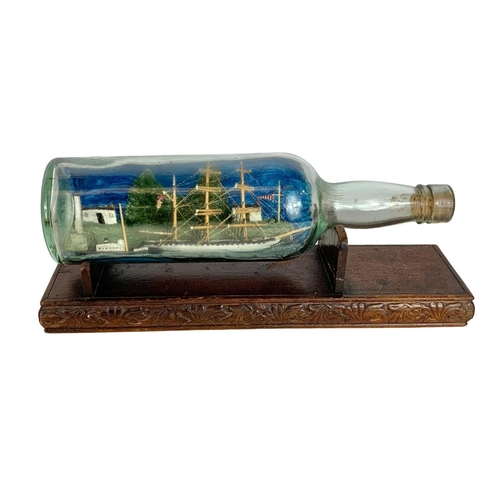 717 - Vintage brass hot water bottle and a ship in a bottle. 32cm.