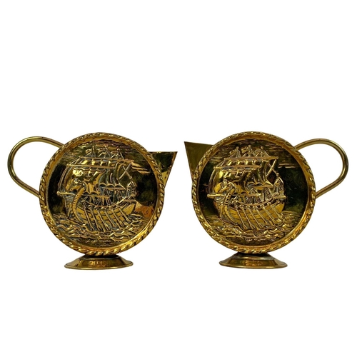 71 - Pair of vintage brass round handled pitchers with Viking longboat theme. Larger of the pair 22 x 18c... 