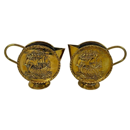 71 - Pair of vintage brass round handled pitchers with Viking longboat theme. Larger of the pair 22 x 18c... 