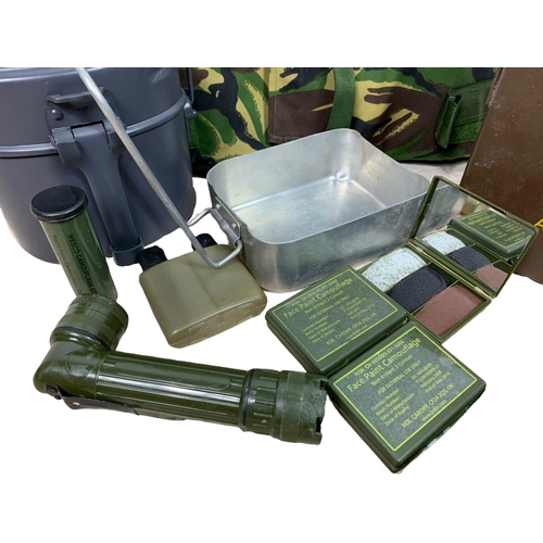 117 - Military equipment. Including a cartridge box, flasks, body armour, camouflage paint, torch etc.