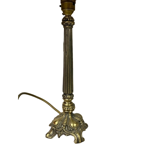 131 - Pair of ornate brass table lamps. Base measures 32cm. With shade 52cm.