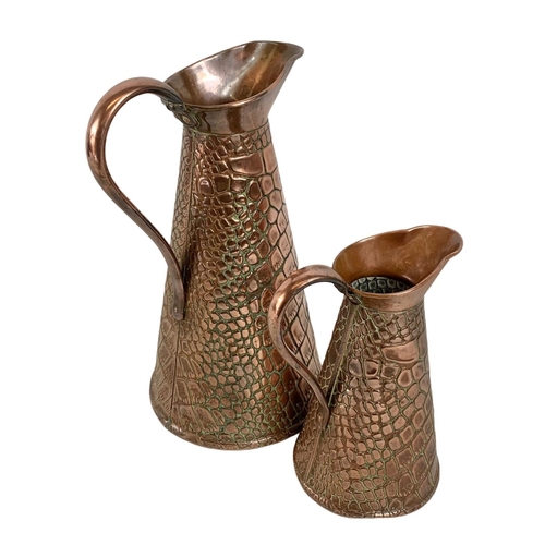 29 - 2 Arts & Crafts copper jugs by J.S&S. circa 1900. largest 26.5.