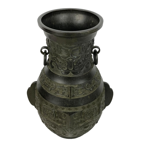 55 - 19th century Chinese bronze alter vase in the Archaistic style with loop handles. 31cm