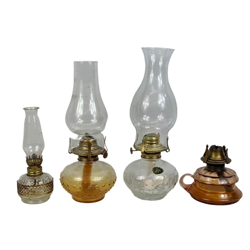 151 - Vintage oil lamps and 2 travelling clocks. Largest lamp 34cm.