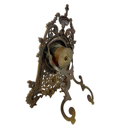 163 - A Victorian brass embossed mantle clock with silvered dial. 32cm.