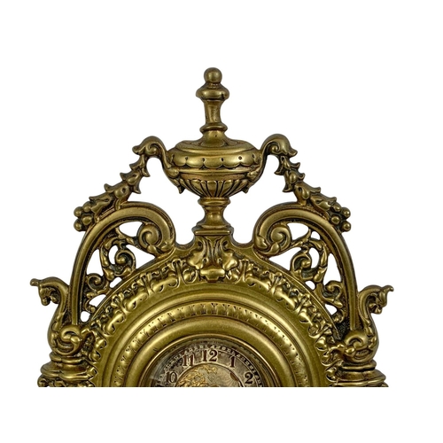 163 - A Victorian brass embossed mantle clock with silvered dial. 32cm.