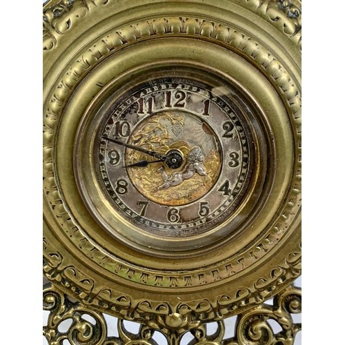 163 - A Victorian brass embossed mantle clock with silvered dial. 32cm.