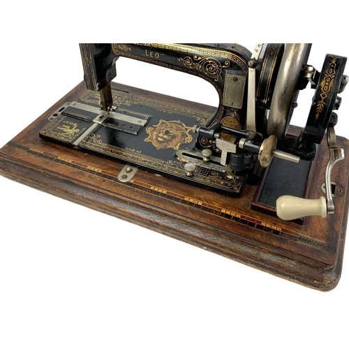 170 - A late Victorian hand turning sewing machine in an inlaid case. With Leo The Lion. Circa 1890/1900. ... 