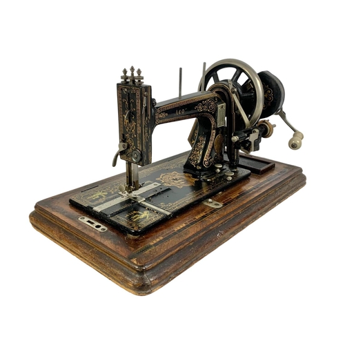 170 - A late Victorian hand turning sewing machine in an inlaid case. With Leo The Lion. Circa 1890/1900. ... 