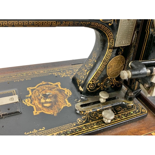 170 - A late Victorian hand turning sewing machine in an inlaid case. With Leo The Lion. Circa 1890/1900. ... 