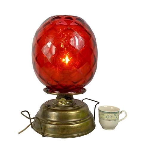 172 - A large vintage Wright & Butler Union Burner lamp with ruby glass shade. 32 x 43cm