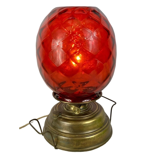 172 - A large vintage Wright & Butler Union Burner lamp with ruby glass shade. 32 x 43cm