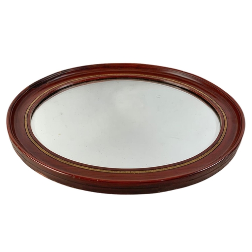 196 - An Edwardian mahogany framed oval mirror. 59 x 49cm