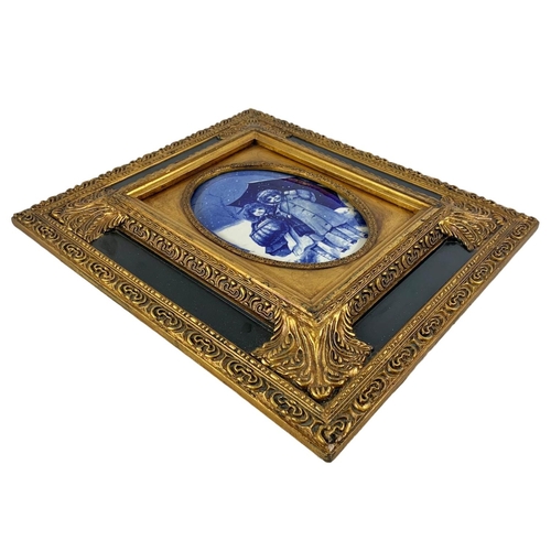 199 - A pair of Carvers & Gilders Picture Makers & Restorers gilt framed blue and white porcelain plaques.... 